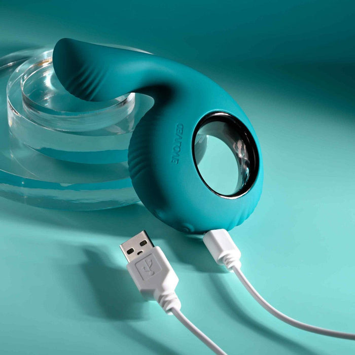 Teal silicone shallow penetration vibrator with a finger loop and magnetic USB charging cable.