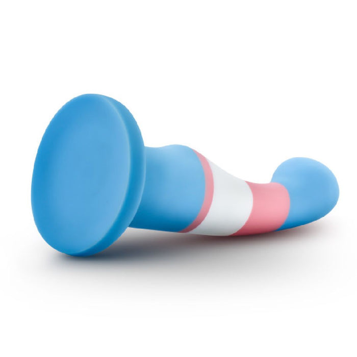 The Trans Pride Slim Curved 6 Inch Silicone Suction Cup Dildo, made from platinum-cured silicone with a flared base and blue, pink, and white stripes, is shown lying on a white background.