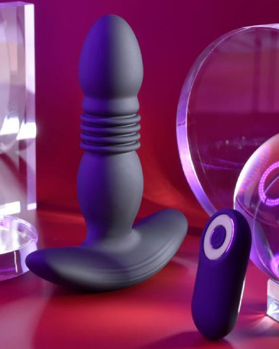 Playboy Trust the Thrust Vibrating & Thrusting Anal Plug with Remote  on burgundy background