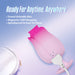 A pink Tulip Trance Licking Sucking Clitoral Vibrator with water droplets and a white magnetic USB charger sits beside a white zippered pouch. Text highlights its travel size, easy cleaning, USB charging, and powerful suction functions.