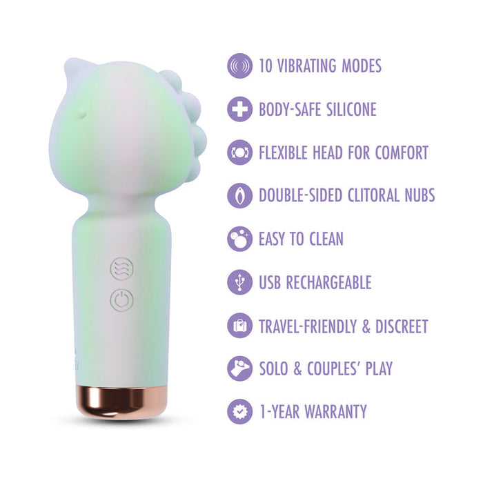The Unicorn Dreams Mini Wand – Magical Pleasure Awaits, shown in pastel green and white with dinosaur accents, features 10 vibration modes, body-safe silicone, a USB rechargeable design, travel-friendly size, and a 1-year warranty.