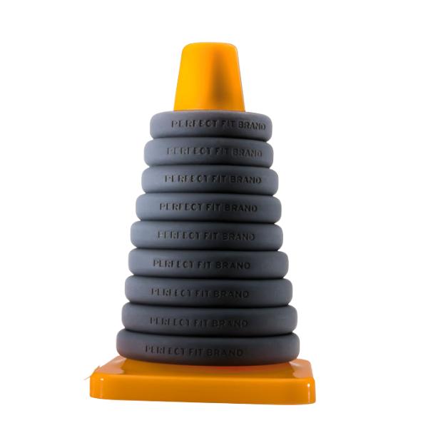 The Perfect Fit Play Zone Cock Ring Kit features eight gray silicone rings labeled "PERFECT FIT BRAND" on a yellow cone post—ideal as cock rings or for erection enhancement.