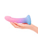 A hand holds the Utopia Sleek 7 Inch Pink and Blue Ombre Silicone Dildo with Suction Cup, perfect for prostate or G-spot stimulation, shown against a white background.