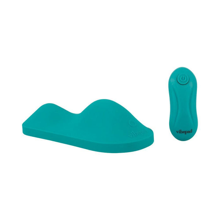 The VibePad Intense Ultra Powerful Ride On Hands-Free Humping Vibrator—a teal, contoured silicone pad with a raised section and matching "vibepad" wireless remote—delivers waterproof, hands-free pleasure and easy control.
