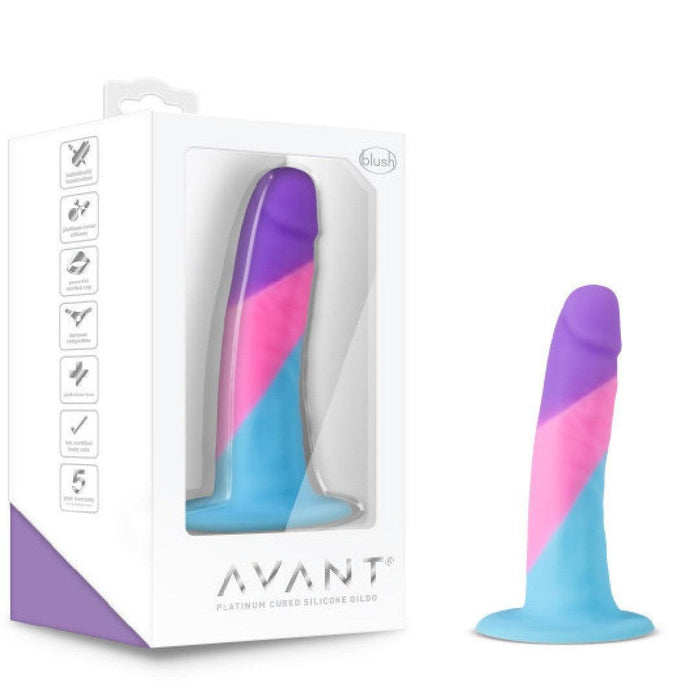 The Vision of Love Tapered 5.5 Inch Silicone Suction Cup Dildo in blue, pink, and purple sits by its white Avant box. The beginner-friendly phallic dildo features premium platinum silicone and a user-friendly curved tip.