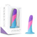 The Vision of Love Tapered 5.5 Inch Silicone Suction Cup Dildo in blue, pink, and purple sits by its white Avant box. The beginner-friendly phallic dildo features premium platinum silicone and a user-friendly curved tip.