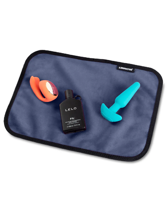 Liberator Fascinator Toy Pad Mini Waterproof Sex Blanket - Blue with toys and lube on it 