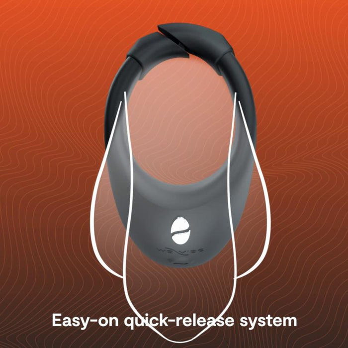 The We-Vibe Bond Vibrating App Controlled Couples Ring, in black with white straps, is shown on an orange wavy background. Text below reads: "Easy-on quick-release system." Control powerful vibrations via the We-Vibe app.