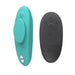 Two remote controls are shown for the We-Vibe Moxie + Hands-Free Remote or App Controlled Panty Vibrator. The teal oval remote has a circular button, while the dark gray one features plus, minus, and power buttons for easy use.