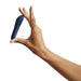 A hand holds the We-Vibe Tango X Powerful Waterproof Bullet Vibrator—small, curved, and dark blue—between the thumb and index finger against a plain white background.