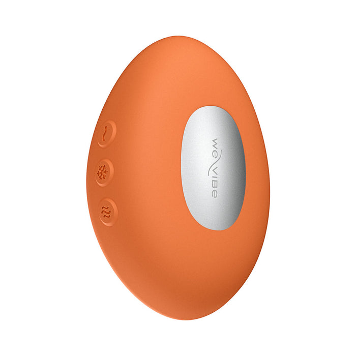 The We-Vibe Temp Lay On Vibrator with Hot and Cold Functions is an orange, oval-shaped device featuring three textured buttons and a silver "We-Vibe" accent, displayed against a white background.