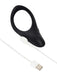 Black silicone We-Vibe Verge 2 vibrating cock ring with a magnetic white USB charging cable on a white background.