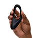 Hand holding a smooth, black silicone We-Vibe Verge 2 vibrating cock ring with a flexible, ergonomic design.
