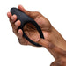 Hand holding a flexible, black silicone We-Vibe Verge 2 vibrating cock ring with a smooth, ergonomic design.