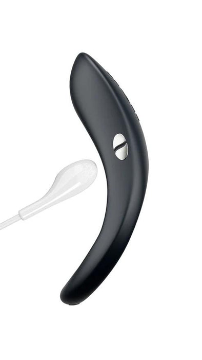 Black silicone We-Vibe Verge 2 cock ring with silver control buttons and a white magnetic charging cable.