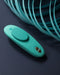 We-Vibe Moxie + Hands-Free Remote or App Controlled Panty Vibrator -  Teal with teal strands on backdrop 