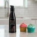 The 4 oz black bottle of Wicked Aqua Birthday Cake Flavored Water Based Lubricant features pink text, a birthday cake with three candles, is paraben-free, long-lasting, and contains 120 ml (4 fl oz).