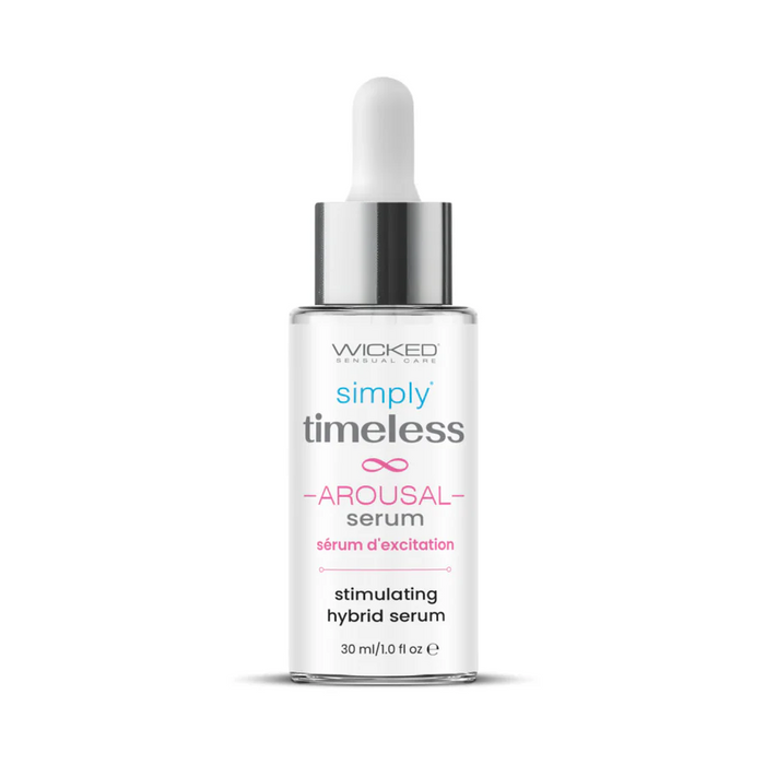 A clear bottle of Wicked Simply Timeless Arousal Serum with a dropper cap, featuring blue, pink, and gray text describing it as a clitoral stimulating hybrid serum, 30 ml (1 fl oz).