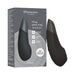 Box and product image of the Womanizer Enhance Pleasure Air + Vibration Clit Stimulator, a sleek black device shown with packaging, featuring 10 intensity levels, powerful rumbly vibrations, and innovative Pleasure Air Technology.