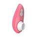 The Womanizer Liberty 2 Pleasure Air Travel Sized Clitoral Stimulator is a pink handheld device with two white buttons and a white circular tip, designed for personal wellness and clitoral pleasure using air technology.