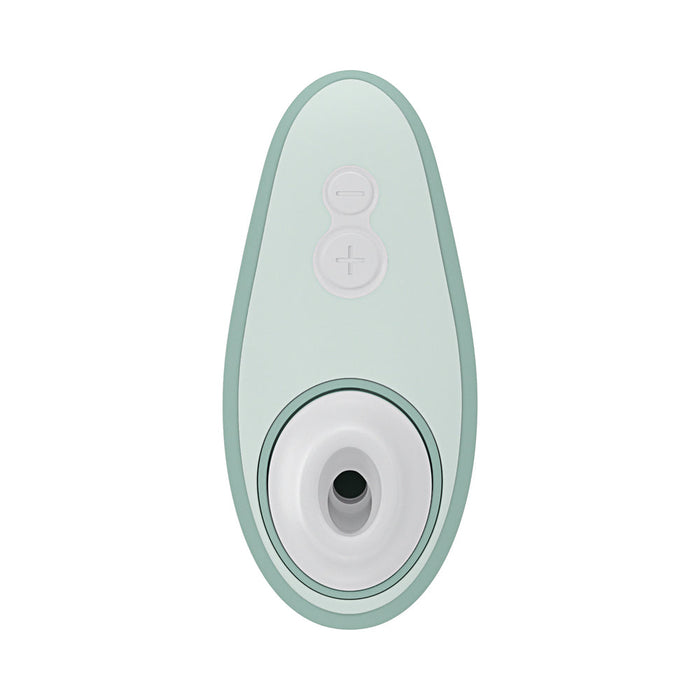 The Womanizer Liberty 2 Pleasure Air Travel Sized Clitoral Stimulator is a mint green, oval waterproof device with plus and minus buttons and a circular opening at one end, designed for clitoral pleasure air technology.