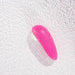 The Womanizer Starlet 3 Pleasure Air Clitoral Stimulator, a pink waterproof massager with a textured surface, rests on a rippled light background—its Pleasure Air technology offers satisfying clitoral suction sensations.