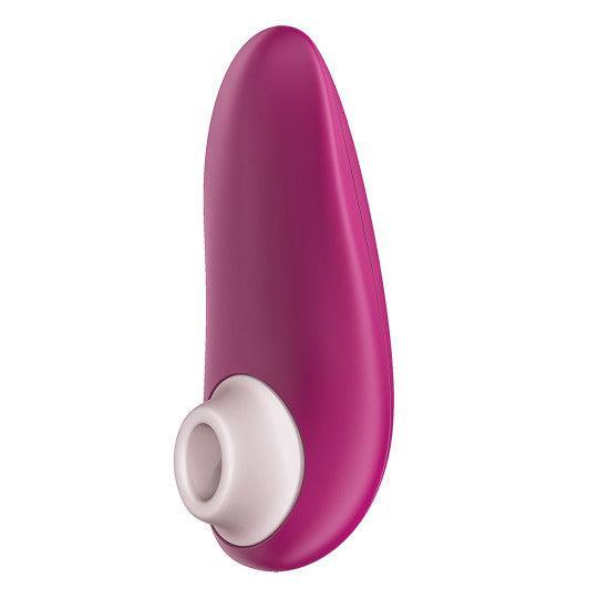The Womanizer Starlet 3 Pleasure Air Clitoral Stimulator is a magenta and white handheld massager with a smooth, curved design and a circular opening for gentle clitoral suction.