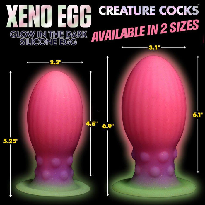 The "Xeno Egg Glow In The Dark Extra Large Thick Silicone Egg" is a vibrant, silicone sex toy with a ribbed design and neon hues that glows in the dark, evoking an alien egg. Measurements and eye-catching colors are clearly displayed.