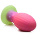 The Xeno Egg Glow In The Dark Extra Large Thick Silicone Egg is a ribbed, pink and green sex toy with a flared base and textured dots near the neck, shown on a white background.