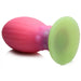 The Xeno Egg Glow In The Dark Extra Large Thick Silicone Egg is a pink and green ribbed plug with a flared round green base, offering safe, comfortable use and a striking glow-in-the-dark look.
