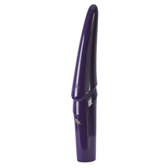 The Zumio X2 Rotating Clitoral Stimulator is a sleek, dark purple cylinder with a tapered, glossy top, crafted for precise clitoral stimulation and shown upright on a white background.