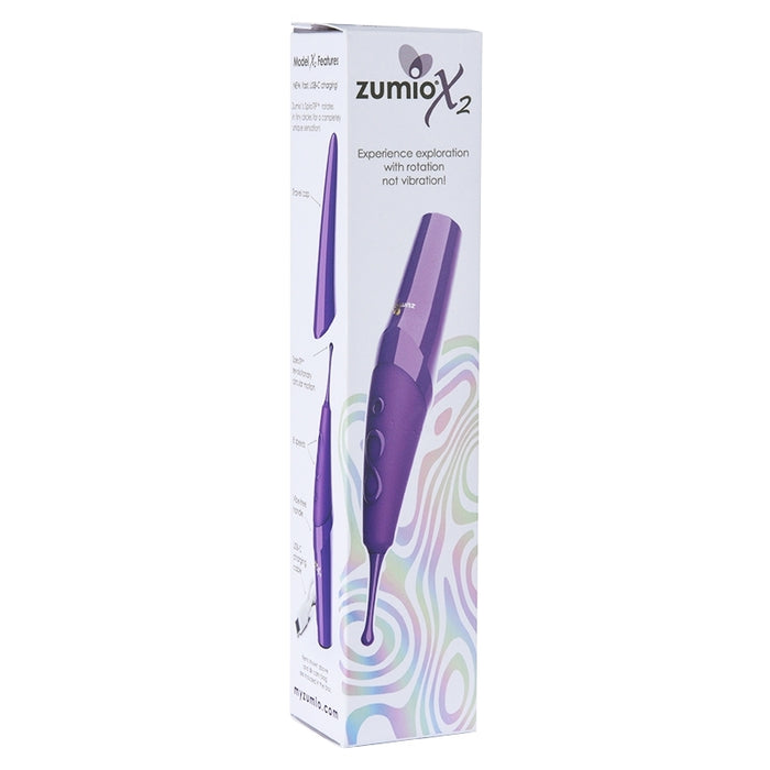 A white box with colorful swirls showcases the Zumio X2 Rotating Clitoral Stimulator, a sleek purple massager with a fine tip for precise clitoral pleasure, beside the phrase “Experience exploration with rotation, not vibration.”.