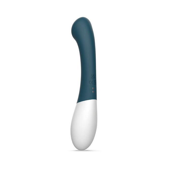 The Zini Soon Silicone G-Spot Vibrator, featuring a curved blue and white design with a rounded tip and made from ultra-soft silicone, stands upright against a plain white background.