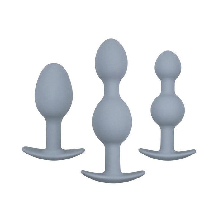 The Adam & Eve Vibra Ball Weighted Butt Plug Trio & Anal Trainers features three seamless grey silicone anal toys of different sizes, each with a flared base, shown upright against a white background.