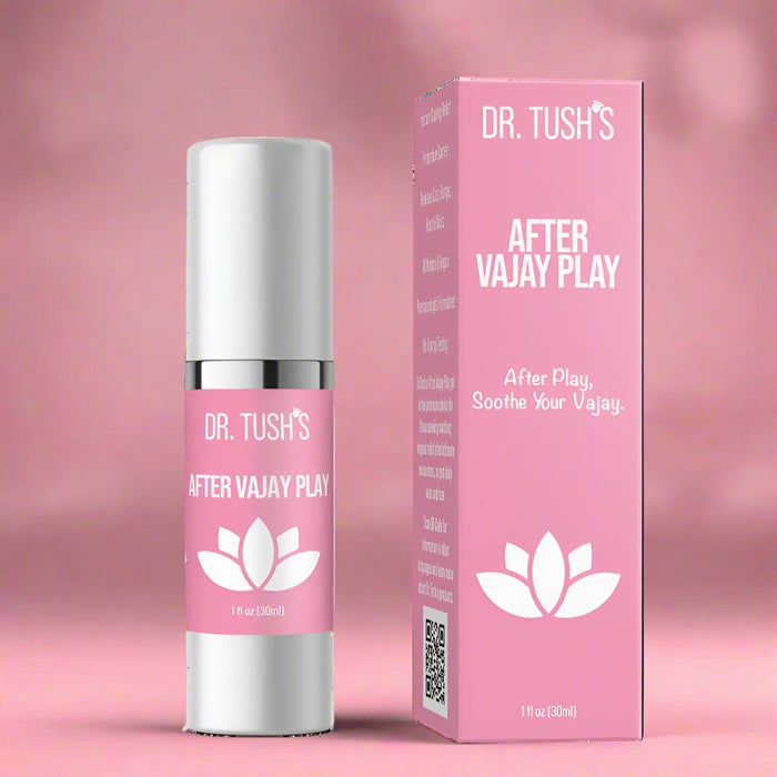 A pink box and matching bottle labeled "After Vajay Play Soothing Lotion by Dr. Tush," featuring a white lotus on a pink background. This pH-balanced feminine lotion soothes and supports intimate skin recovery after play.