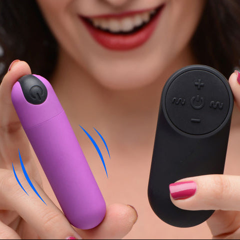 A smiling woman holds a BANG! Vibrating Bullet with Remote Control: the small, powerful purple bullet in one hand, the black buttoned remote in the other. Her red nails and lips pop, with blue motion lines highlighting its vibrant sensations.