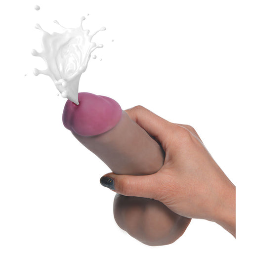 A hand holding the Loadz Squirting 7 Inch Chocolate Tone Dildo - Squeeze and Squirt, designed for a realistic dual density feel.