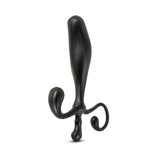 The Anal Adventures Prostate Stimulator - Black by Blush is a sleek and curved black prostate massager made from premium silicone. It features a bulbous, tapered head at the top and two curved extensions at the base for ergonomic handling. This waterproof toy is standing upright against a white background.