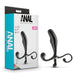 Image of a boxed product labeled "Anal Adventures Prostate Stimulator - Black" by Blush. The packaging showcases a black prostate massager with two curled handles at the base, made from premium silicone. The product is displayed both inside the packaging and next to it, emphasizing its waterproof design and distinctive features.
