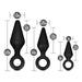 Image of Blush's Anal Adventures Silicone Loop Anal Training Butt Plug Set, featuring three black body-safe silicone anal plugs with ring handles at the base. From left to right: the largest plug is 5.25 inches long with a 1.5-inch width, the medium plug is 4.5 inches long with a 1.25-inch width, and the smallest black tapered plug is 3 inches long with a 1-inch width.
