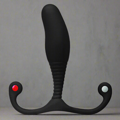 The black Aneros MGX Syn Trident Hands-Free Prostate Stimulator by Aneros features a curved, ribbed handle and a bulbous insertable end. Its ergonomic design includes two looped grips, one with a small red accent, ensuring ease of use for achieving intense prostate orgasms.