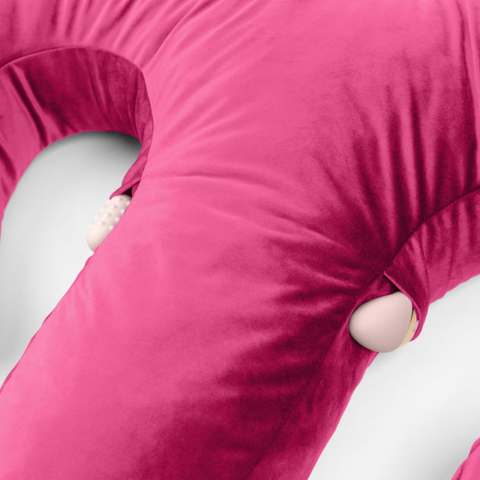 Close-up of the Liberator Arie Toy Mount Snuggle Pillow in bright pink, featuring two side pockets with partially visible beige vibrators against its soft fabric surface.