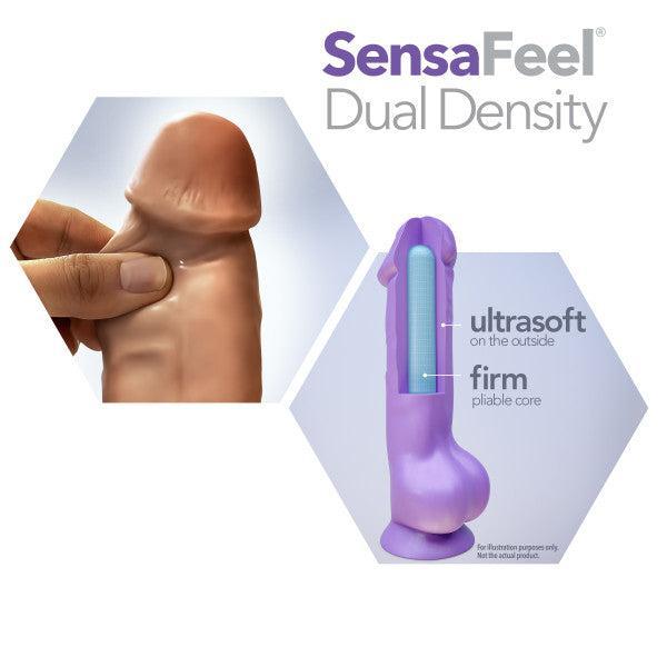An advertisement for the Au Naturel 9.5 Inch Dual Density Suction Cup Dildo - Mocha by Blush. The image shows a realistic dildo being pressed to demonstrate its ultrasoft, body-safe exterior. Next to it is a cutaway view of the dildo highlighting its firm, pliable core and strong suction cup. The Blush logo is at the top right.