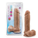 Packaging and product of a realistic-looking, mocha-colored dildo with a strong suction cup base labeled "Au Naturel 9.5 Inch Dual Density Suction Cup Dildo - Mocha." The body-safe item by Blush is placed next to its packaging, standing upright.