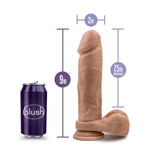 The Blush Au Naturel 9.5 Inch Dual Density Suction Cup Dildo in Mocha is displayed alongside a can for size comparison. This realistic, body-safe dildo measures 9 inches in total length, with an insertable length of 7.5 inches and a diameter of 2 inches. The dildo features a strong suction cup base, while the "Blush" labeled can appears shorter in height than the dildo.
