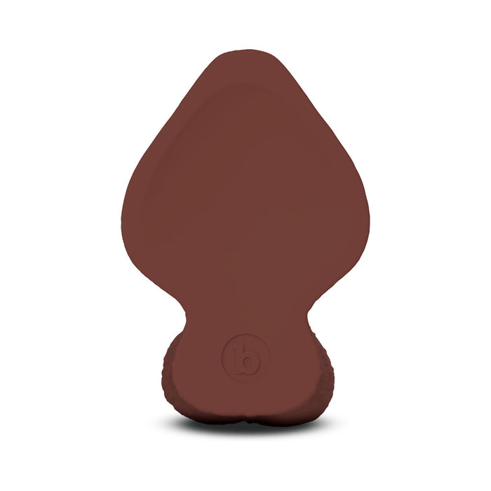 The b-Vibe Slipskin Realistic 6 Inch Girthy Dark Tone Silicone Dildo features a smooth, lifelike brown design with a wide rounded top, narrow base, and subtle circular logo near the bottom. Leaf-like details enhance its realistic appearance.