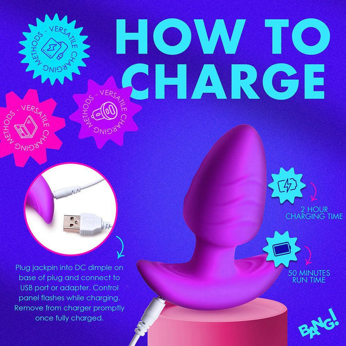 Infographic on how to charge the BANG! Rotating & Vibrating Silicone Butt Plug with Remote by XR Brands. The image depicts the silky-smooth silicone butt plug connected to a USB cable and notes a 2-hour charging time for 50 minutes of run time. The text emphasizes versatility, ease of charging, and the importance of removing it from the charger once fully charged.