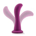 The Bellatrix 6.25 Inch G-Spot and Prostate Dildo in Plum Purple by Blush features an ergonomic silicone design with a smooth, curved shape and a flared base. Motion blurs in the image suggest flexibility and movement, making it perfect for g-spot or prostate stimulation. The white background ensures the product stands out clearly.