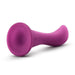 A plum purple silicone dildo named Bellatrix from the brand Blush, featuring a smooth, tapered design with a flared base, perfect for prostate stimulation. The surface is matte, and the 6.25-inch dildo is shown lying on its side.