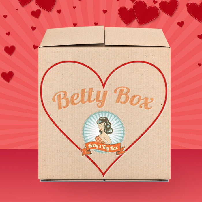 The "Betty's Boundless Booty Mystery Box - Valentine's 2026 Edition" comes in a cardboard box with a large red heart and retro-style woman illustration—perfect for your Valentine’s mystery box desires.